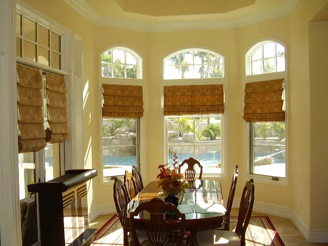A coastal San Diego living room featuring natural woven wood shades that filter the sunlight beautifully.
